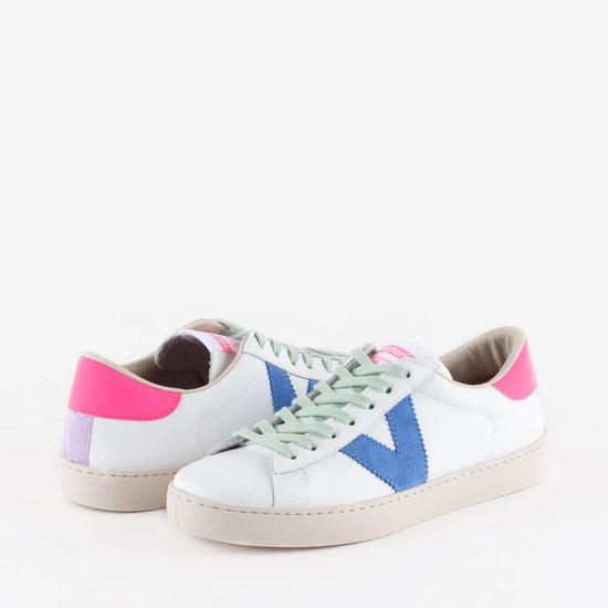 White faux leather trainer with green laces and contrast pink heel tab and suede blue V on outer side