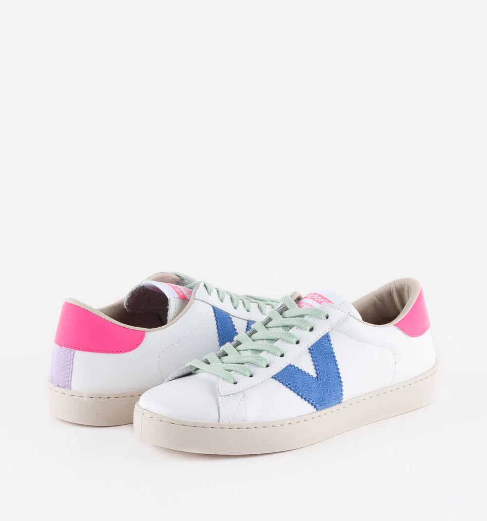 White faux leather trainer with green laces and contrast pink heel tab and suede blue V on outer side
