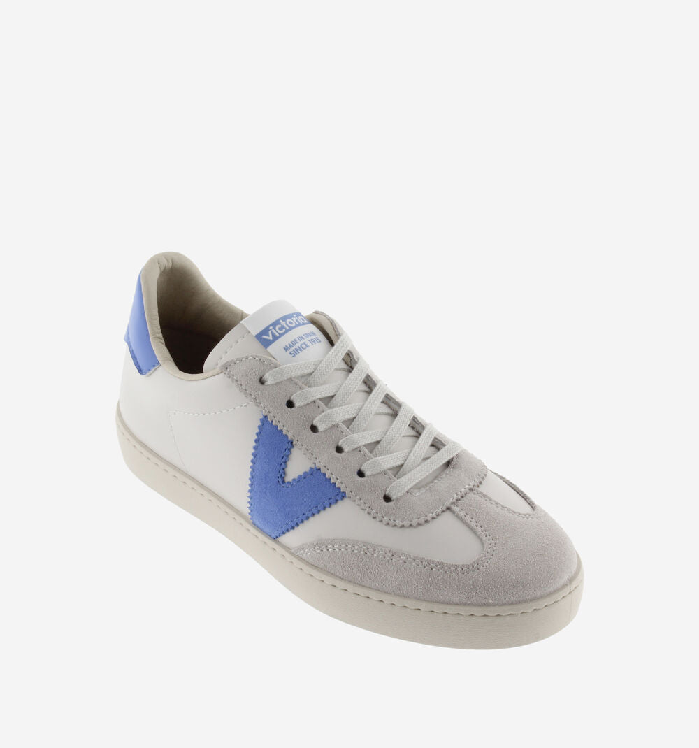 White leather pumps with suede toe flat rubber sole and contrast blue "V" on the outer side and heel tab