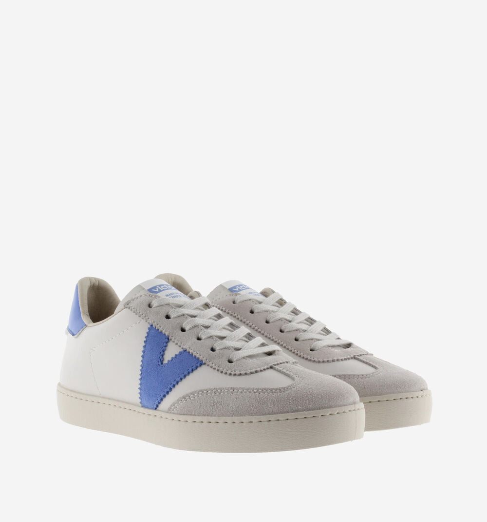 White leather pumps with suede toe flat rubber sole and contrast blue "V" on the outer side and heel tab