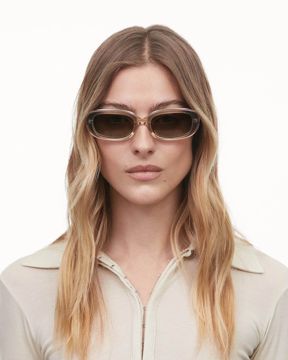 Ecru acetate soft edged rectangular sunglasses with a brown lense model shot