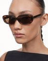 Tortoise shell oval frame in Italian acetate with a brown lense on model