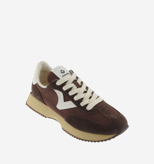 chocolate brown trainers with white v and serrated tread front view 