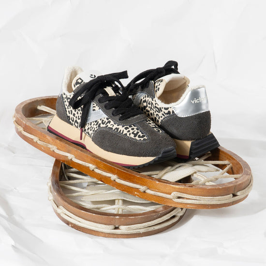 black trainers with silver v, animal print and black laces with fleece interior 