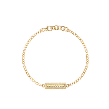Gold bracelet with a bar charm on a white background from Anna Beck