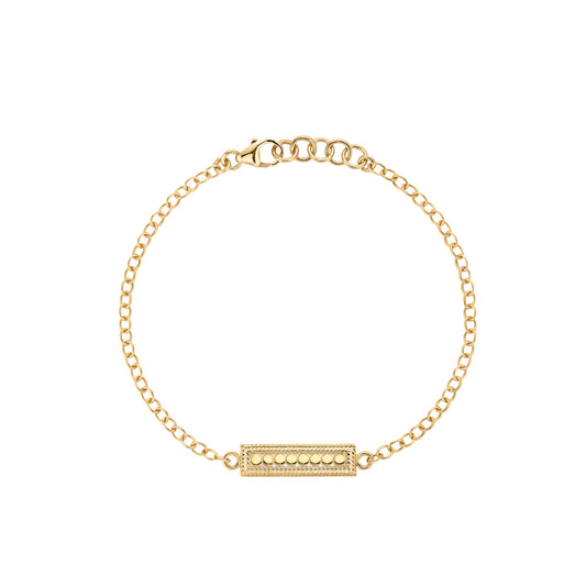 Gold bracelet with a bar charm on a white background from Anna Beck