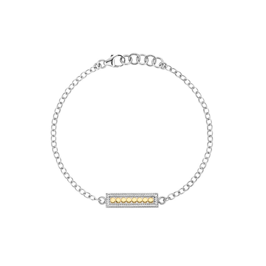 Silver bracelet with a gold bar charm on a white background from Anna Beck