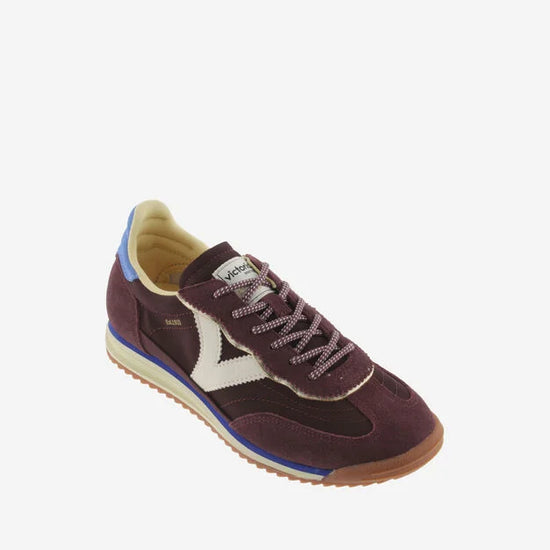 burgundy baseball style trainers with blue back, white v and a serrated tread front view 