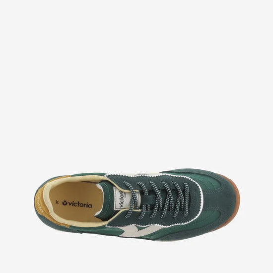 green baseball style trainers with yellow back, white v and a serrated tread birds eye view