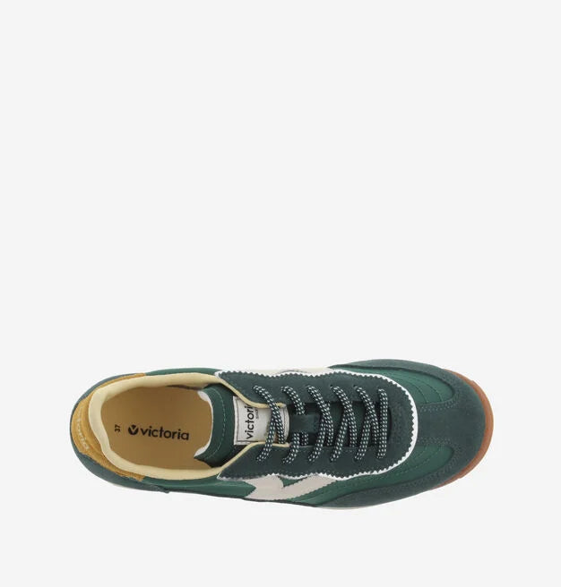 green baseball style trainers with yellow back, white v and a serrated tread birds eye view