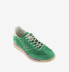 green suede trainers with white laces and serrated tread and pink edging 