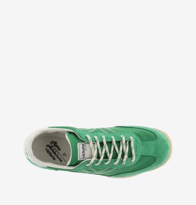 green suede trainers with white laces and serrated tread and pink edging birds eye