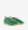green suede trainers with white laces and serrated tread and pink edging front view