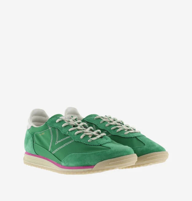 green suede trainers with white laces and serrated tread and pink edging front view