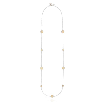 Long silver station necklace with alternating small and medium silver discs with gold dot details