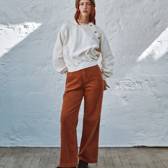 round frill neck cream sweatshirt with button shoulder detailing model shot