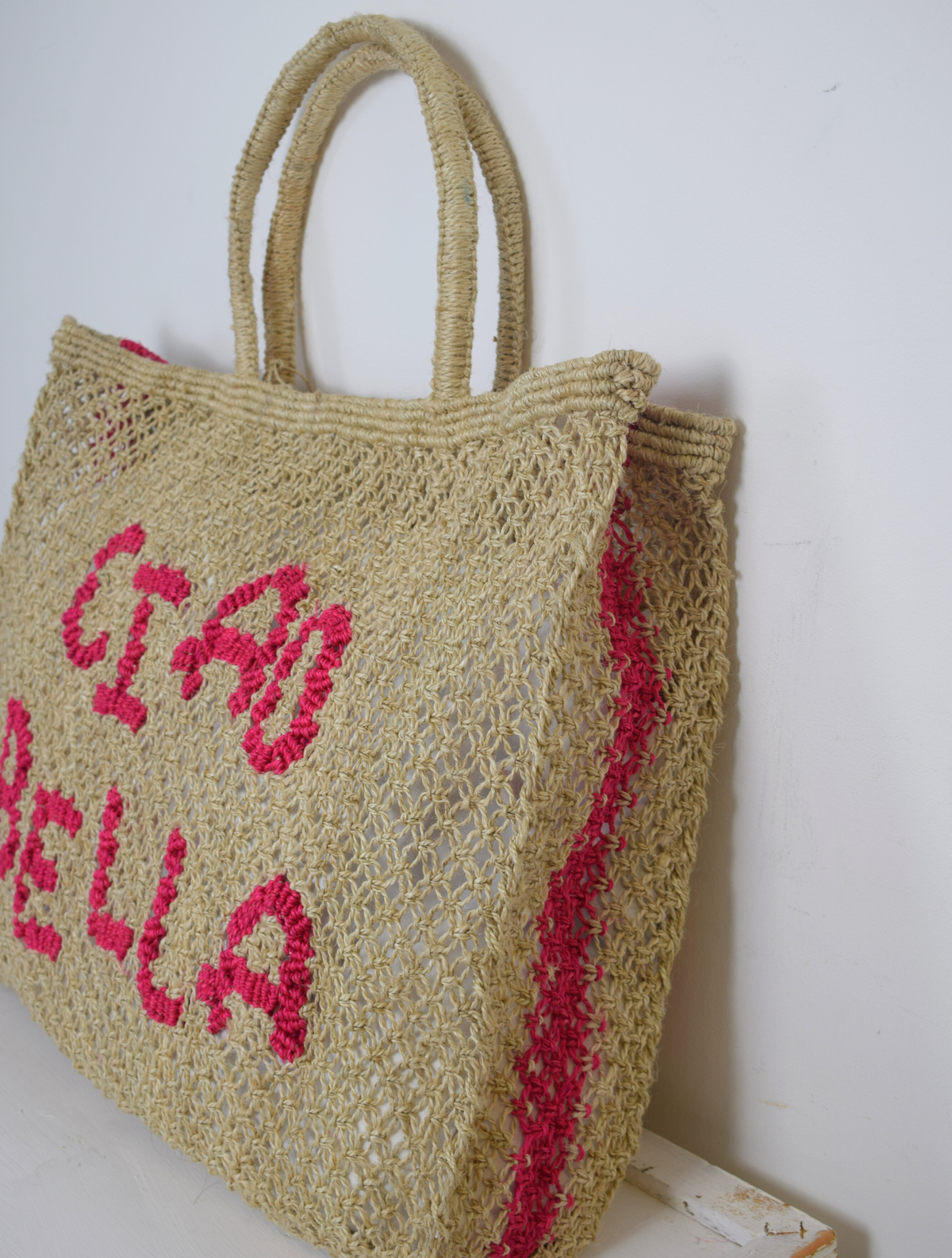 Woven Bag with pink writing saying Ciao Bella on the front