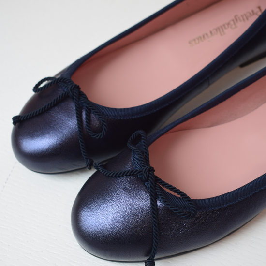 Shimmer navy blue classic round toe ballet pumps with navy thin ribbed binding and navy thin rope bow on toe