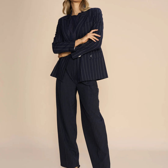 Tapered leg navy and white pinstripe tailored trousers with front pleats and side pockets