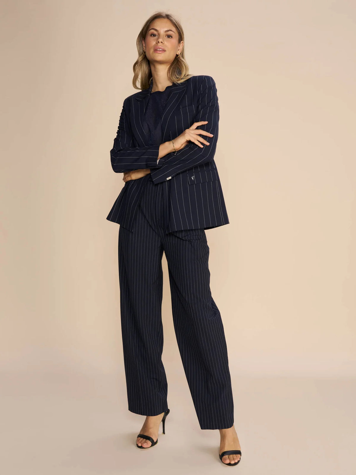 Tapered leg navy and white pinstripe tailored trousers with front pleats and side pockets