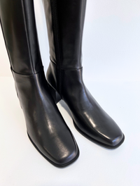 Tall black leather boot with inside zip fastening squared round toe and black leather covered heel