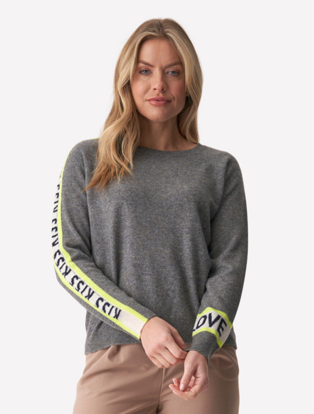 Grey jumper with white writing down the sleeves that says love and kisses
