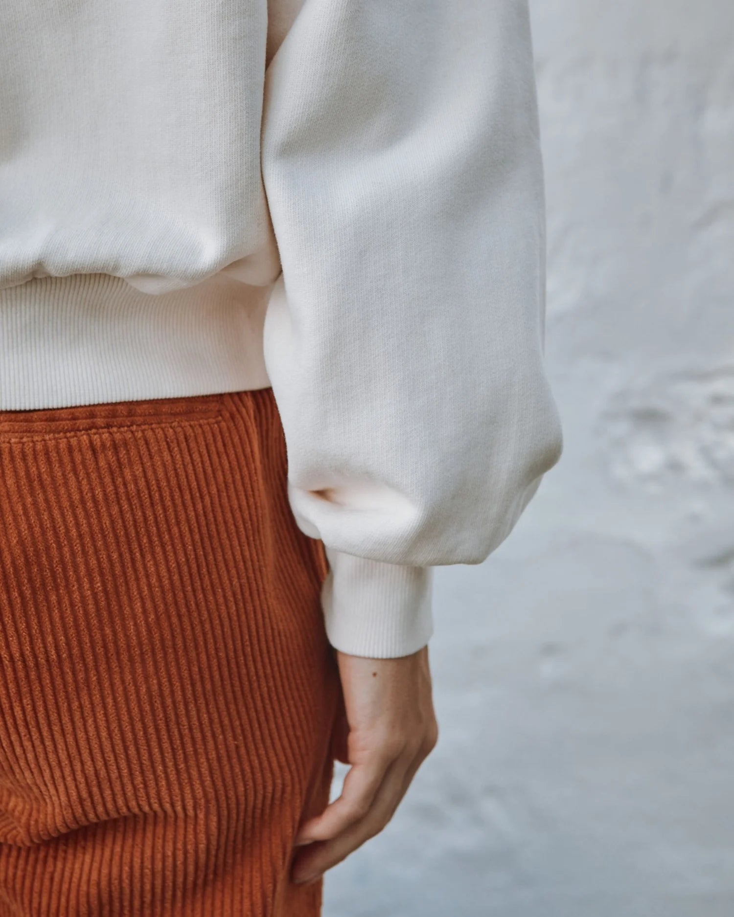 round frill neck cream sweatshirt with button shoulder detailing close up