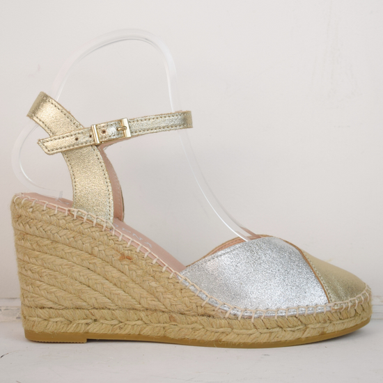 A raffia wedge sandal with a 2 tone top. Made up of silver and gold.