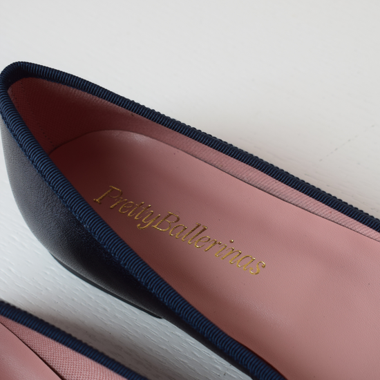 Shimmer navy blue classic round toe ballet pumps with navy thin ribbed binding and navy thin rope bow on toe