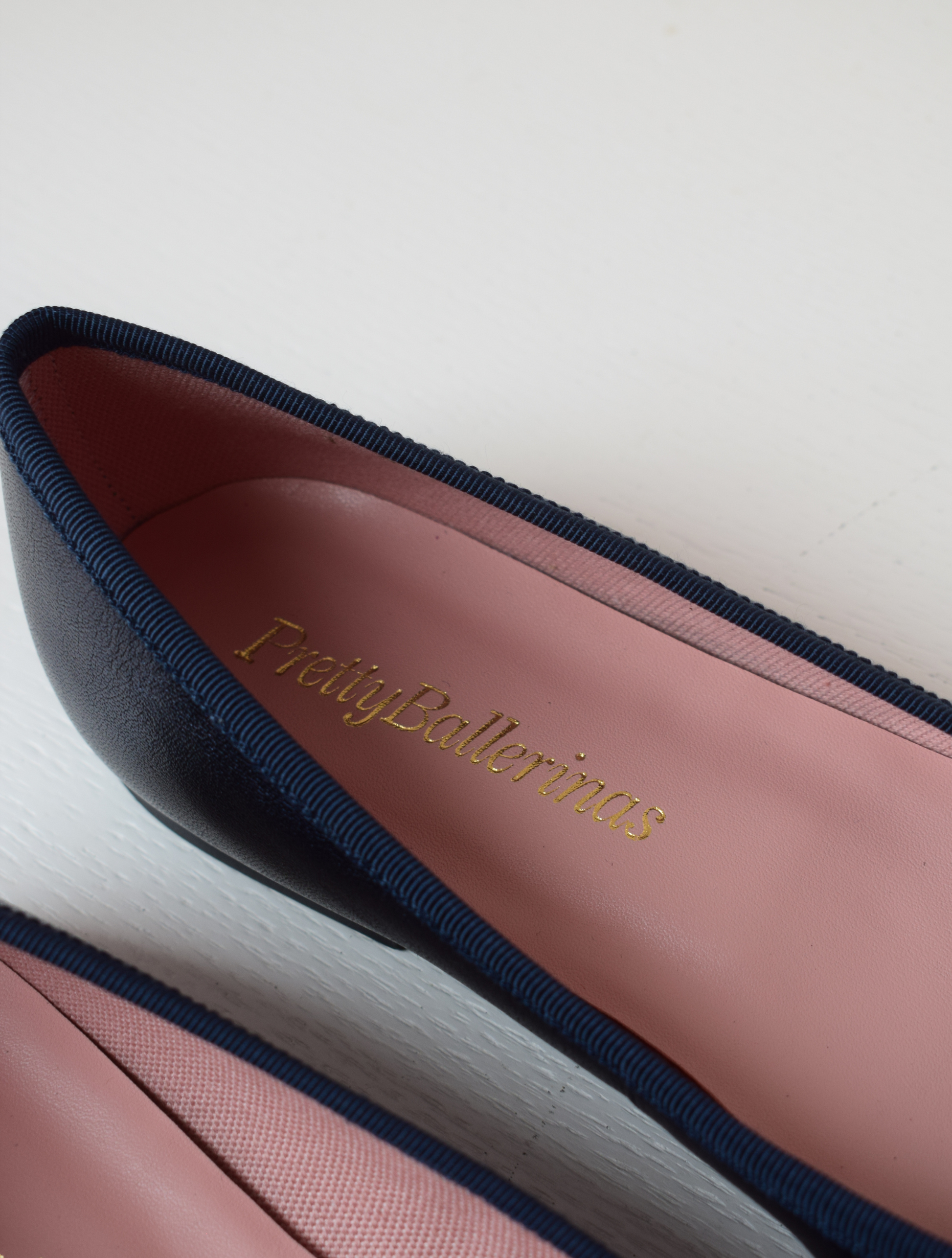 Shimmer navy blue classic round toe ballet pumps with navy thin ribbed binding and navy thin rope bow on toe