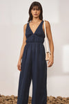 Navy wide leg jumpsuit with deep V neckline and thick tie straps at the back with white contrast stitching