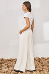 White wide leg trousers with elasticated waistband and drawstring with crinkle fabric