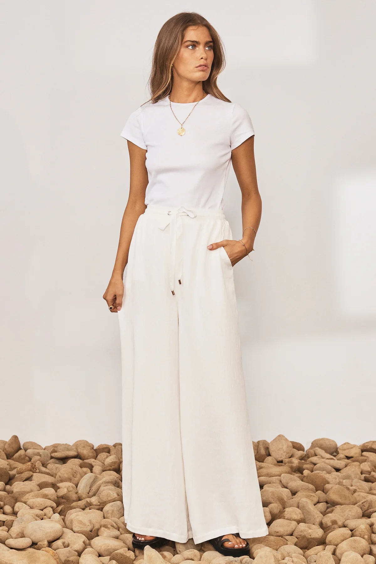 White wide leg trousers with elasticated waistband and drawstring with crinkle fabric
