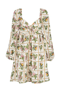 Short A line dress with twisted front sweetheart neckline and long blouson sleeves on ecru background with blossom print on a grid design
