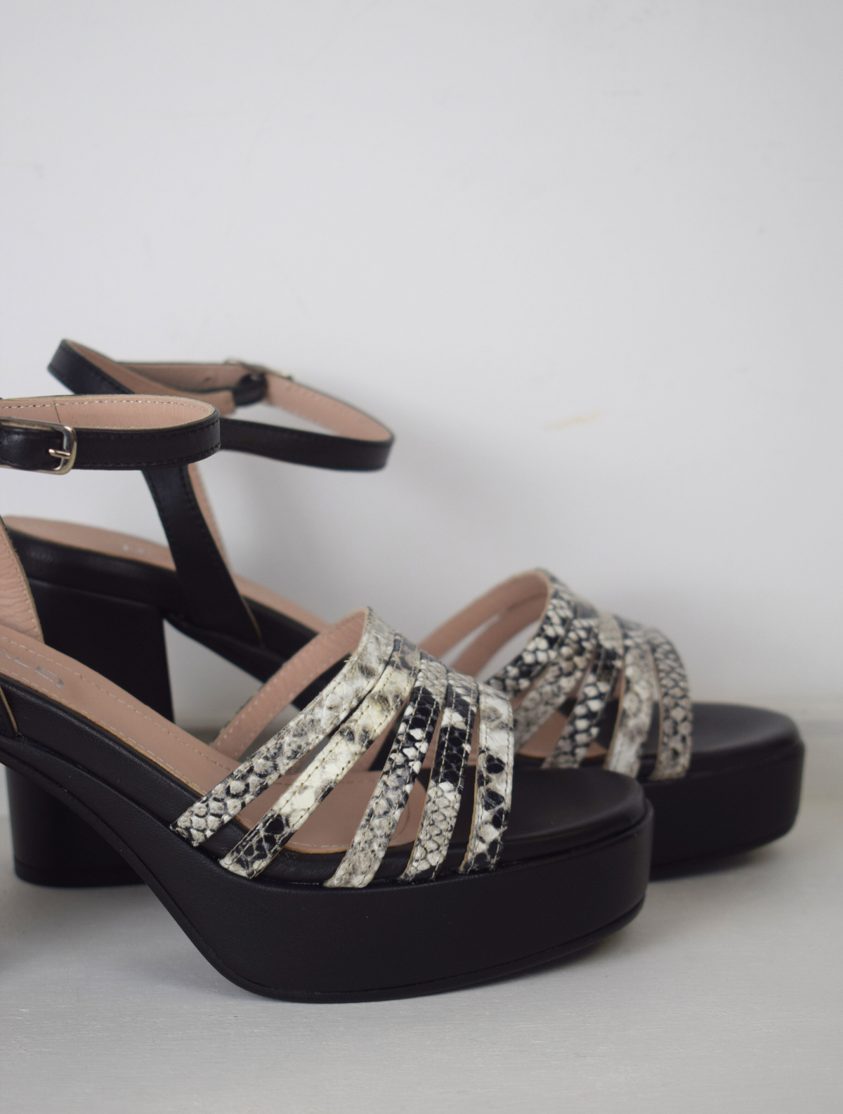 Black platform heel with snake skin straps 