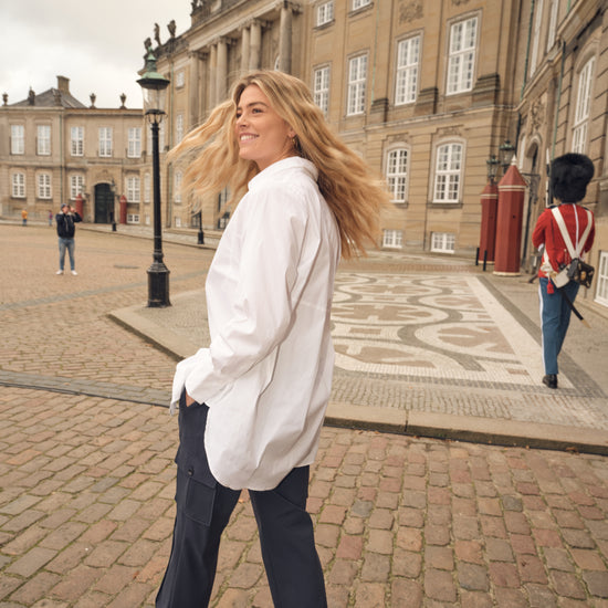 white shirt with concealed placket, curved hem and classic collar model shot rear view