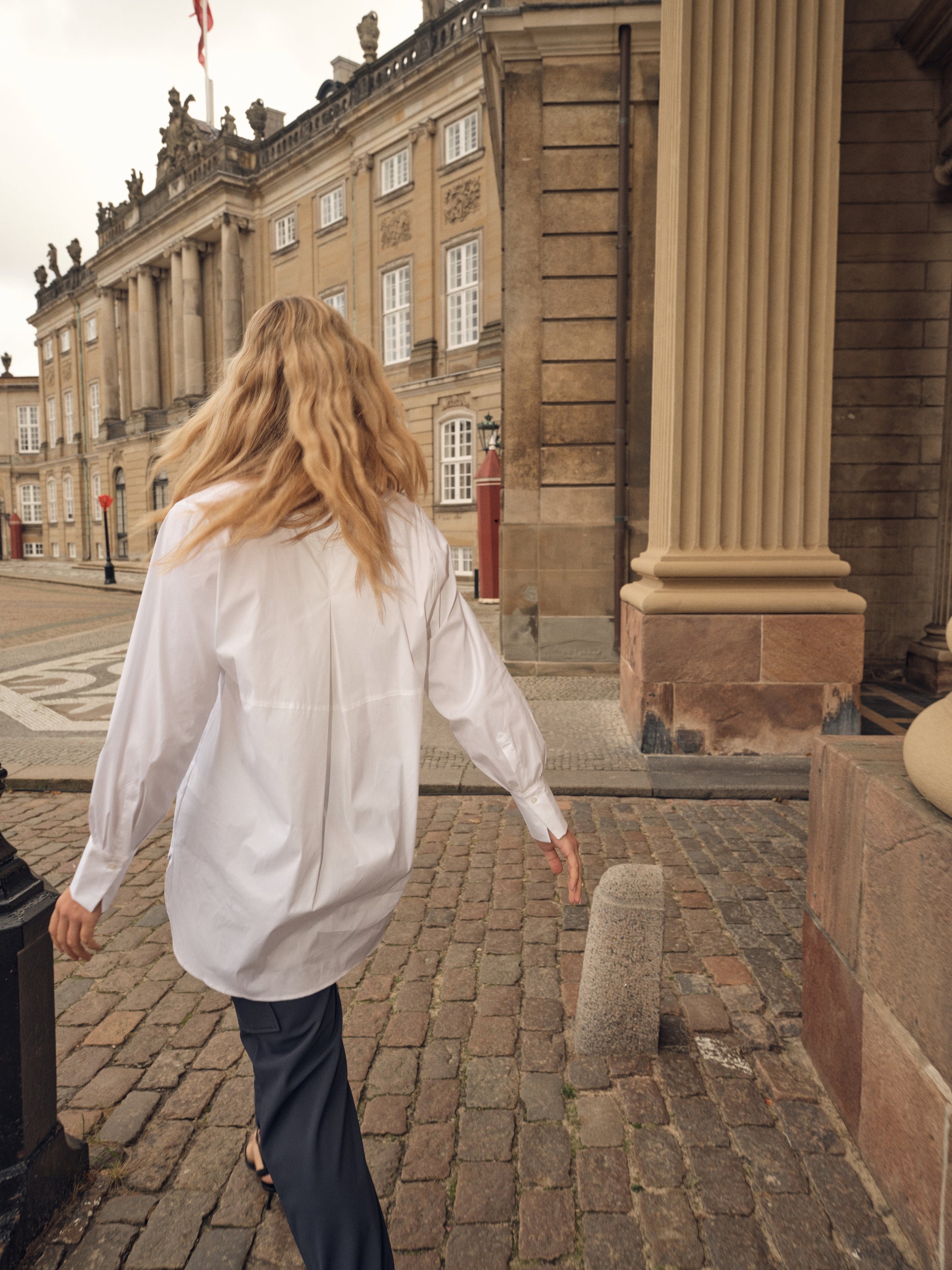 white shirt with concealed placket, curved hem and classic collar model shot rear view