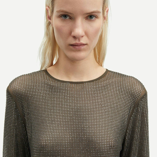 dark grey mesh top covered in rhinestones with round neck and long sleeves  close up