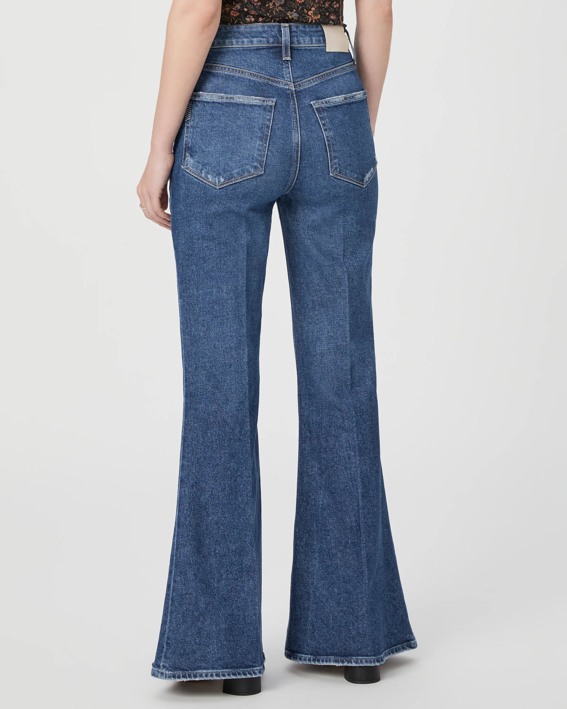 Medium blue high waist jeans with flared bottom rear view