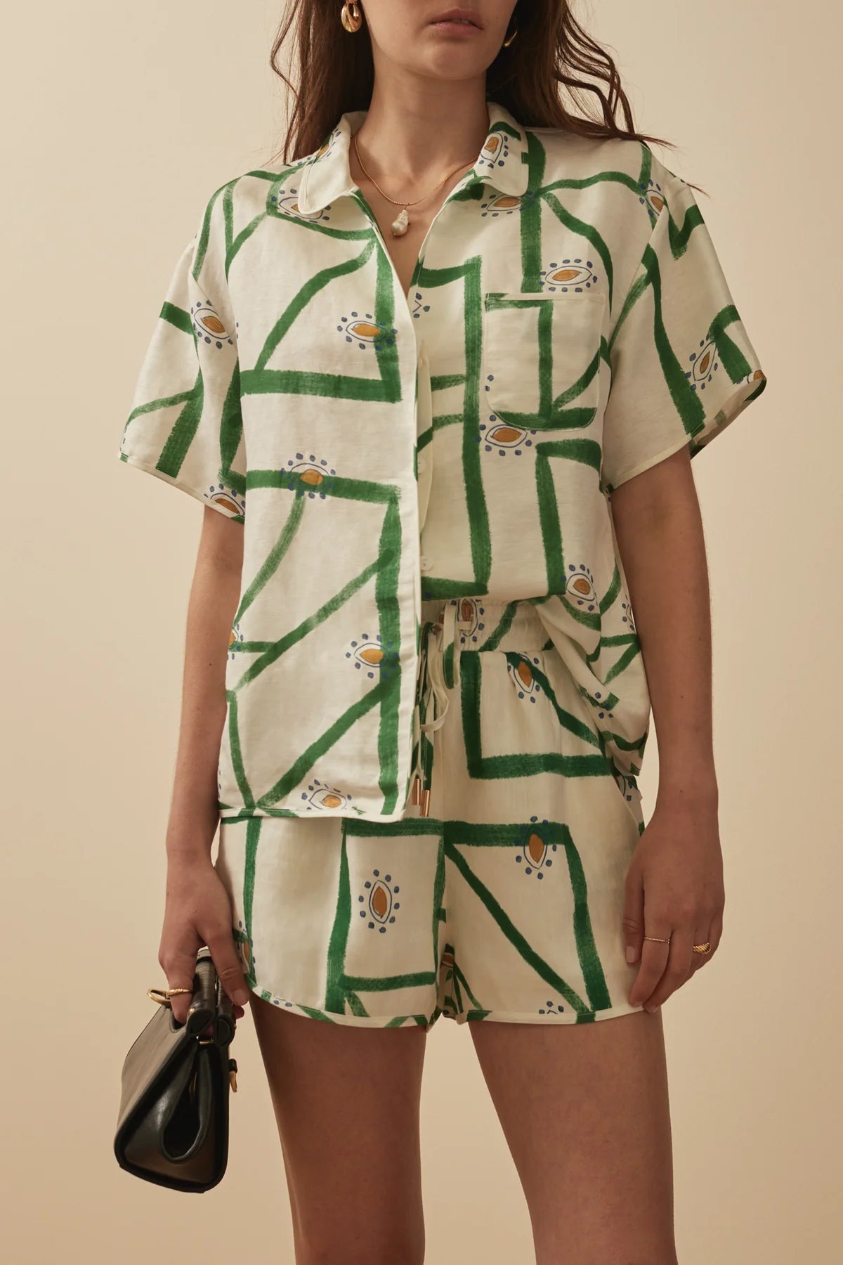 White short sleeved shirt with a green print