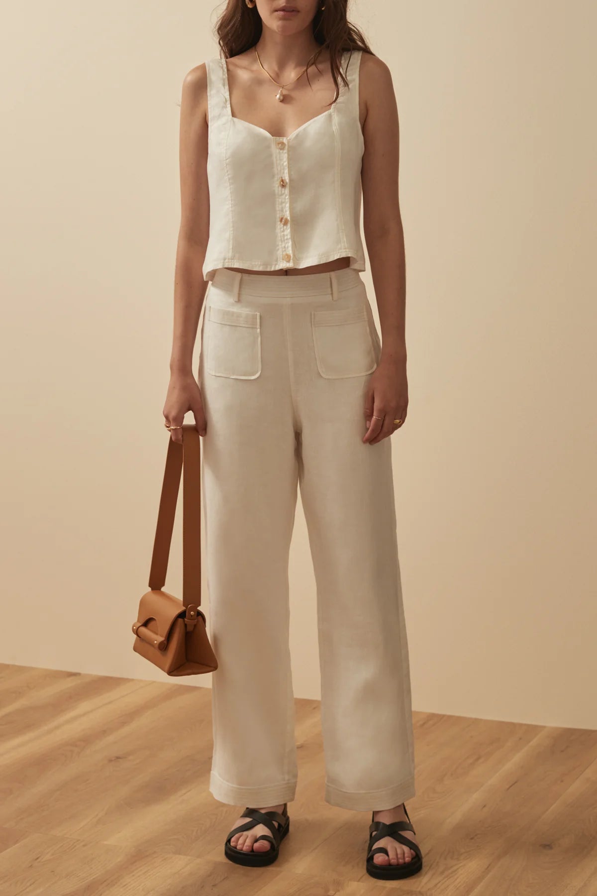 White linen trousers with patch pockets and top stitching