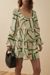 Short dress with long balloon sleeves with a green and gold print