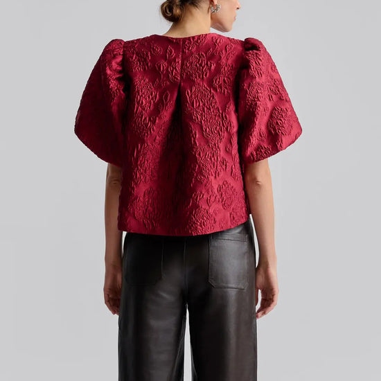 red puff sleeve top with hook eye fastening rear view 