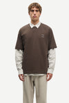 Man wearing a Brown Samsoe Samsoe T shirt over a shirt