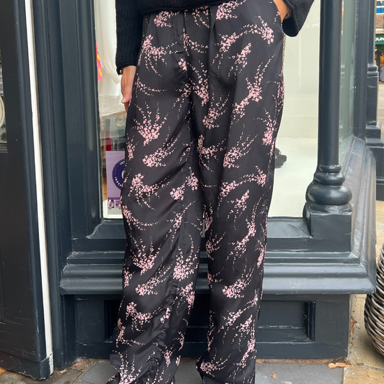 Black trousers with a pink firework print 