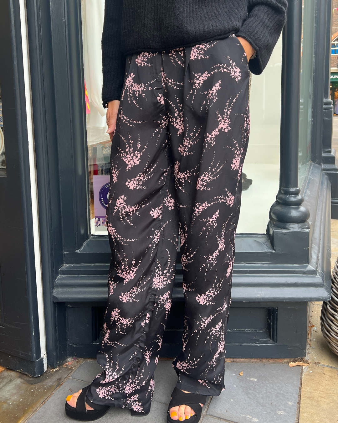 Black trousers with a pink firework print 