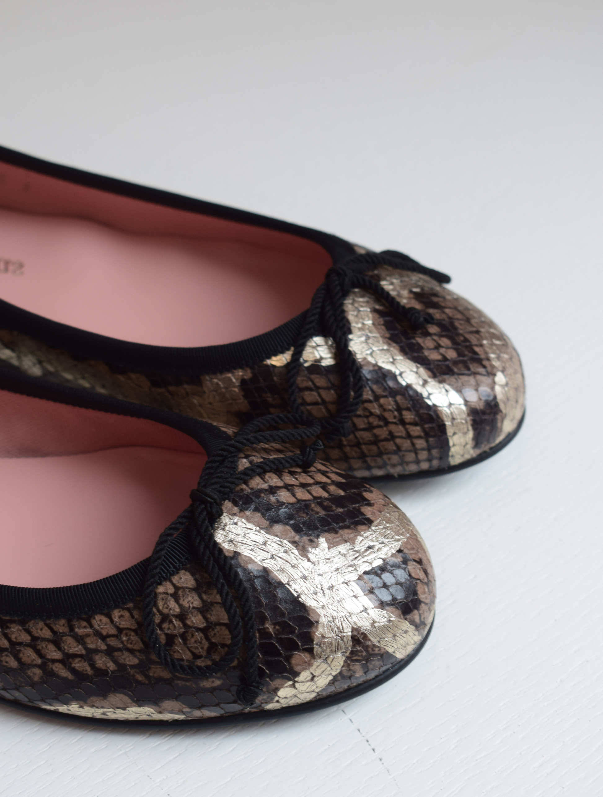 Mock snake leather ballet pumps with black bow on toe with gold shimmer detail