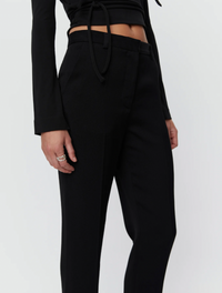 Black tapered tailored flat fronted trousers with side pockets and centre creases