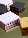 Rachel Jackson boxes on a reflective surface