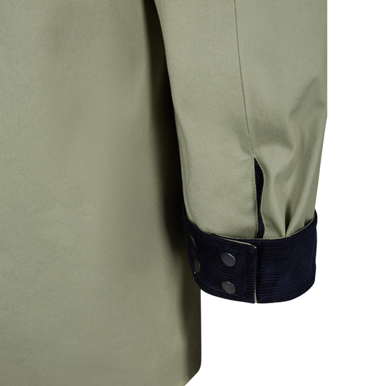 Close up of a jacket cuff turned up with navy cord showing 